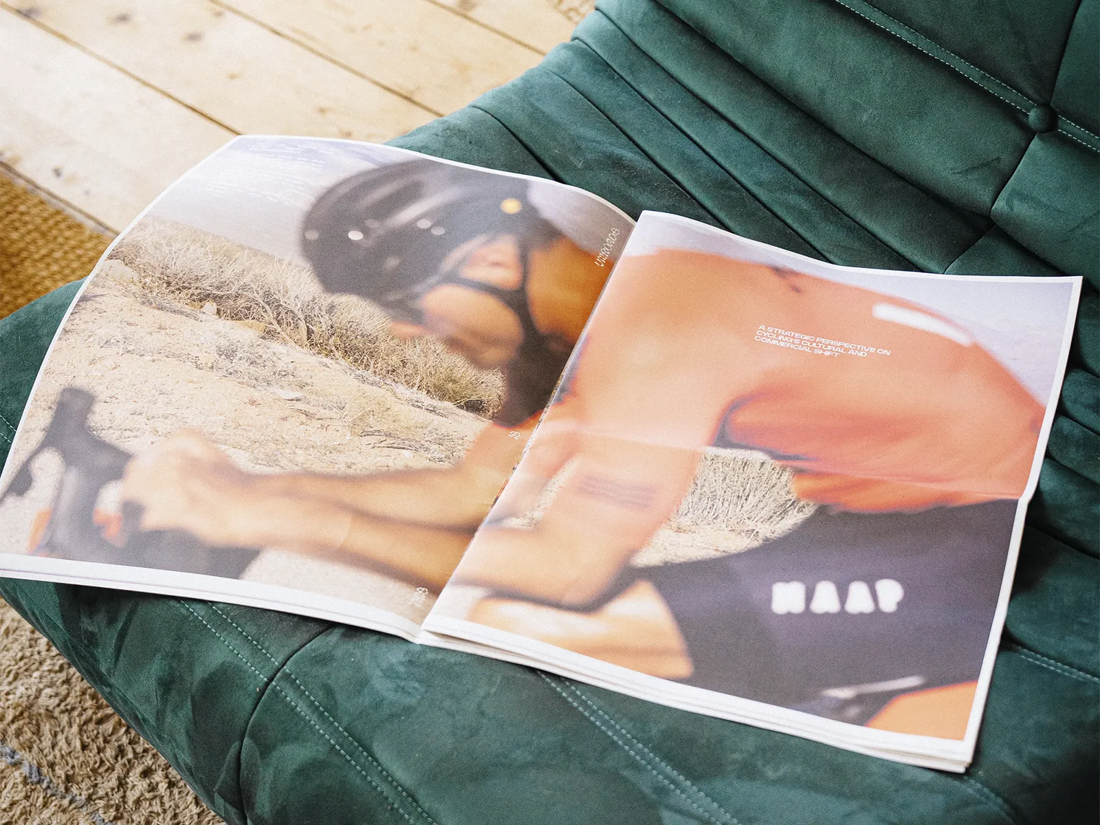 Unroads newspaper spread featuring a cyclist in motion, laid out on a green chair