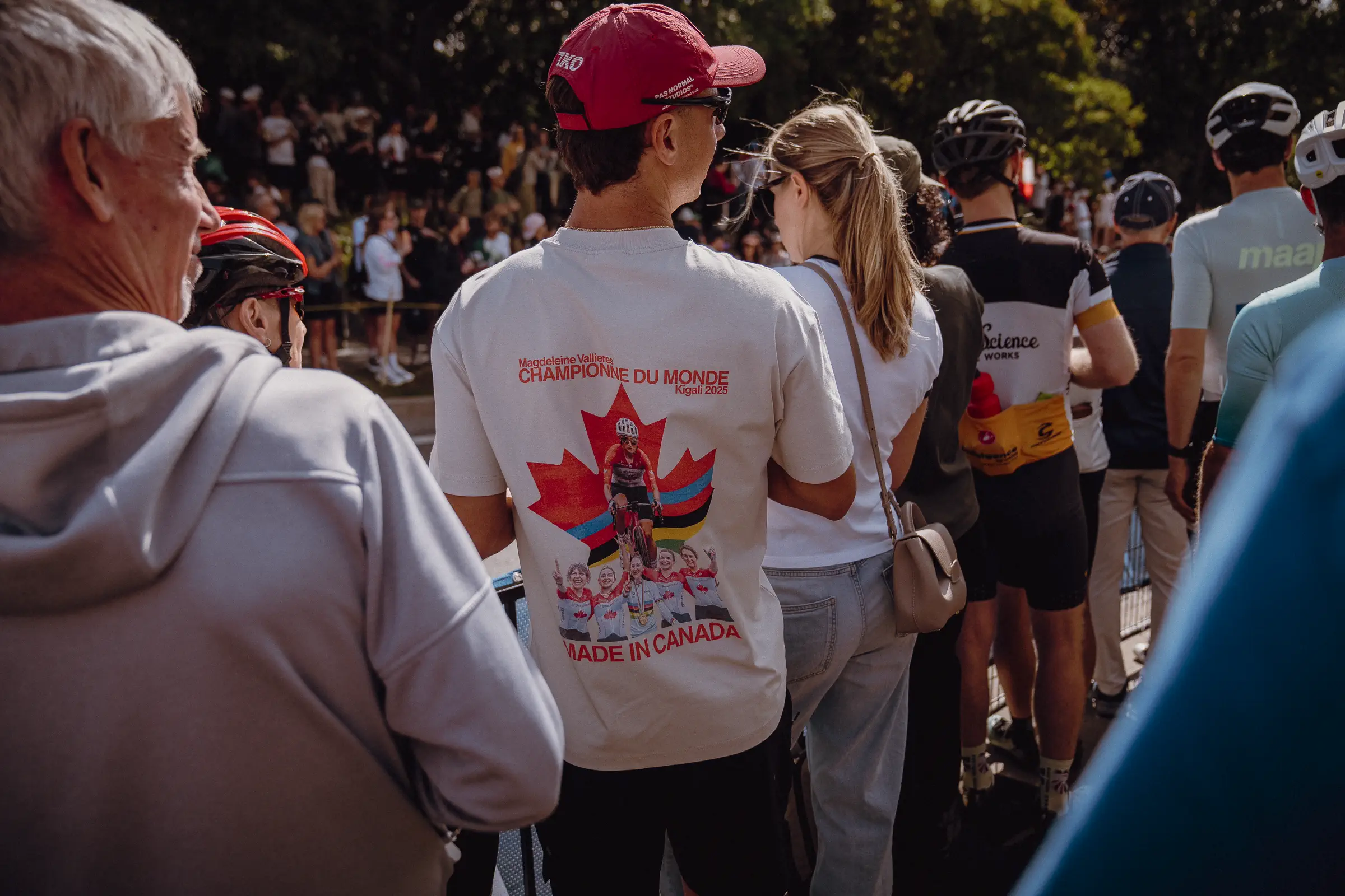 Spectators in team and event shirts gather shoulder to shoulder beside the Montréal course