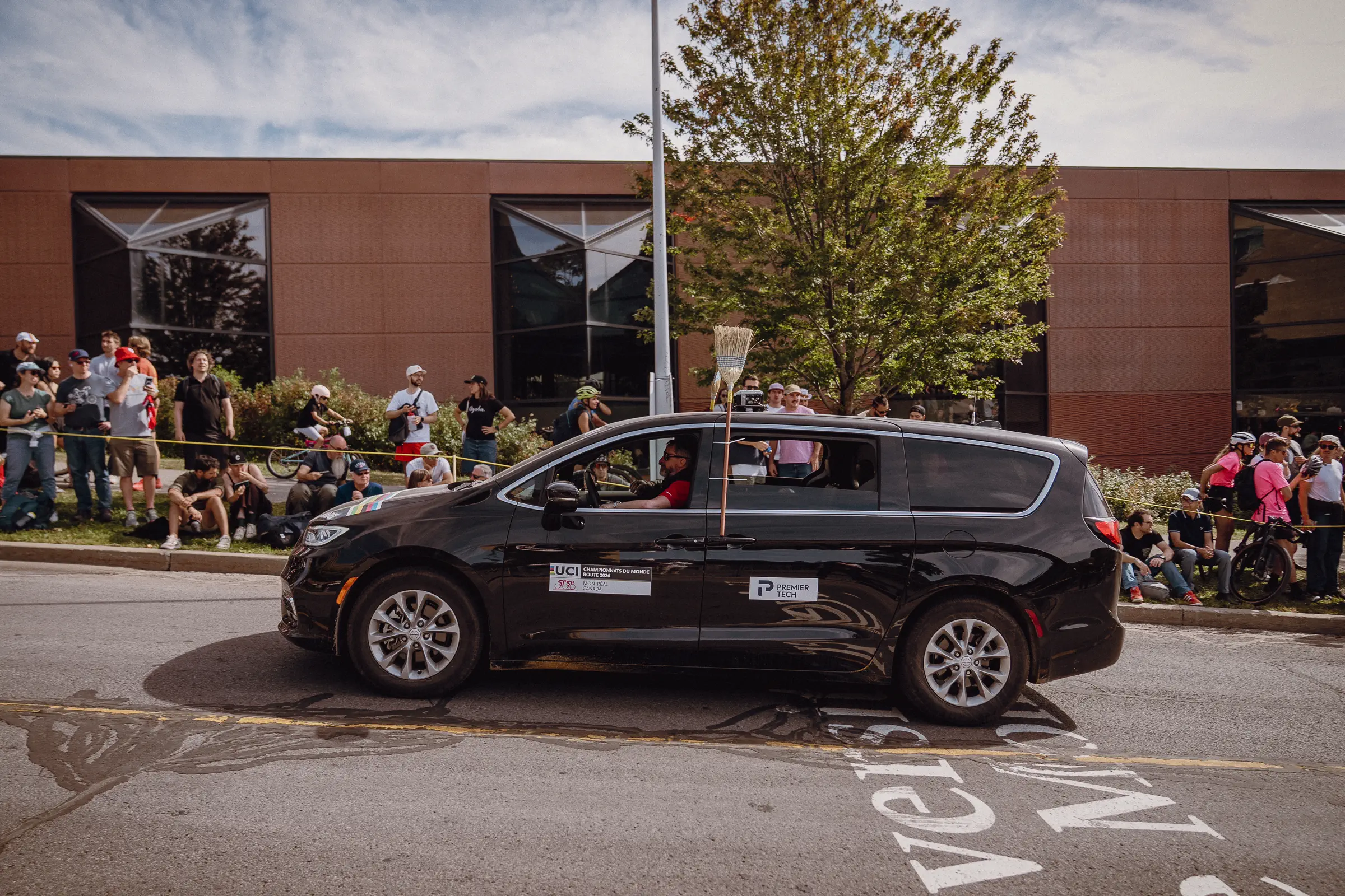 An official vehicle rolls through the course as the final race-day activity begins to disperse