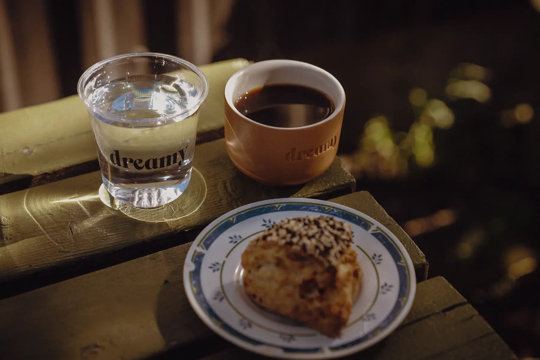 Coffee, water and a pastry sit on a small table during a pause in race week