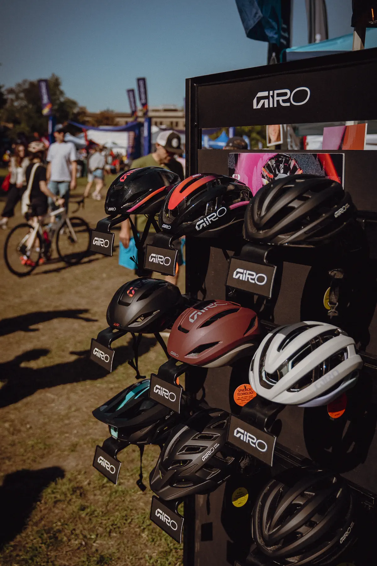 Helmets and race equipment are stacked tightly together in a temporary team setup