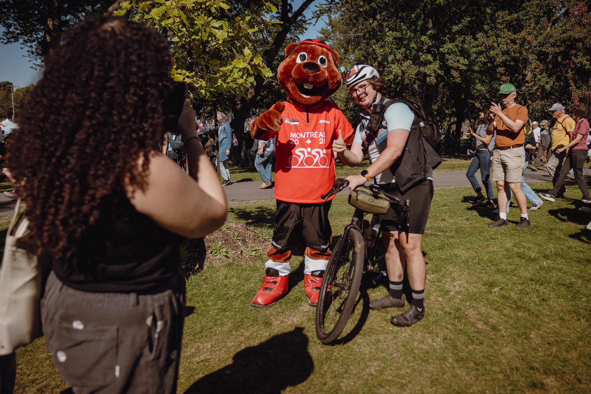 A costumed fan and nearby spectators share a playful moment away from the racing line