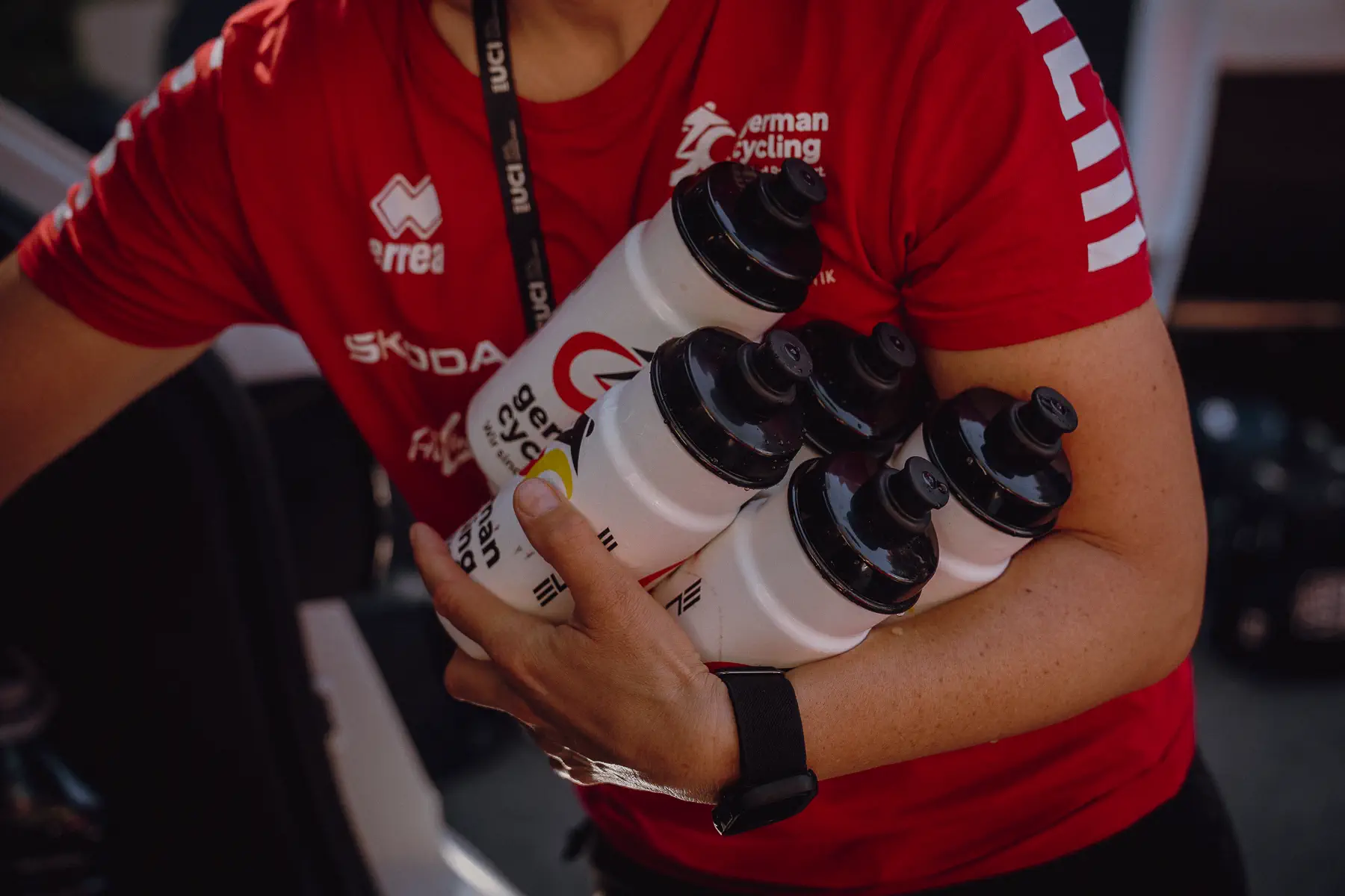 A team staffer carries a bundle of race bottles through the Worlds paddock before the start
