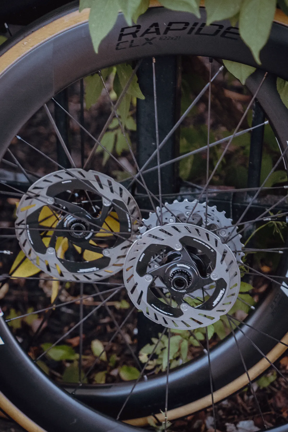 A close view of a race wheel, disc rotor and team equipment in the service area