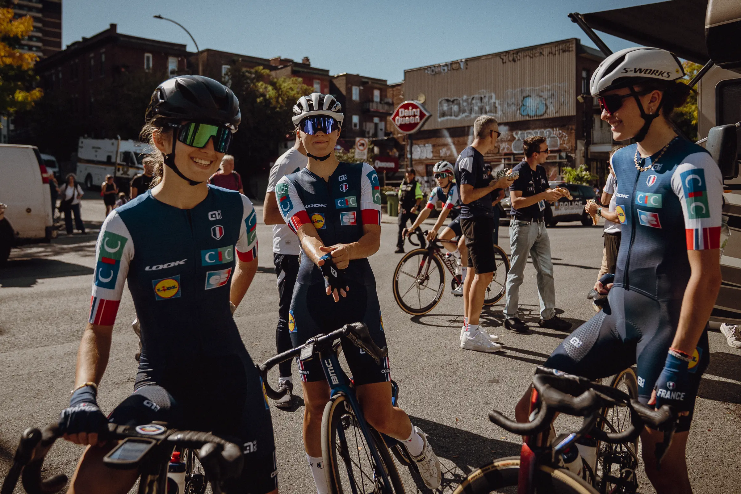 National-team riders gather with their bikes during a quiet course-recon moment