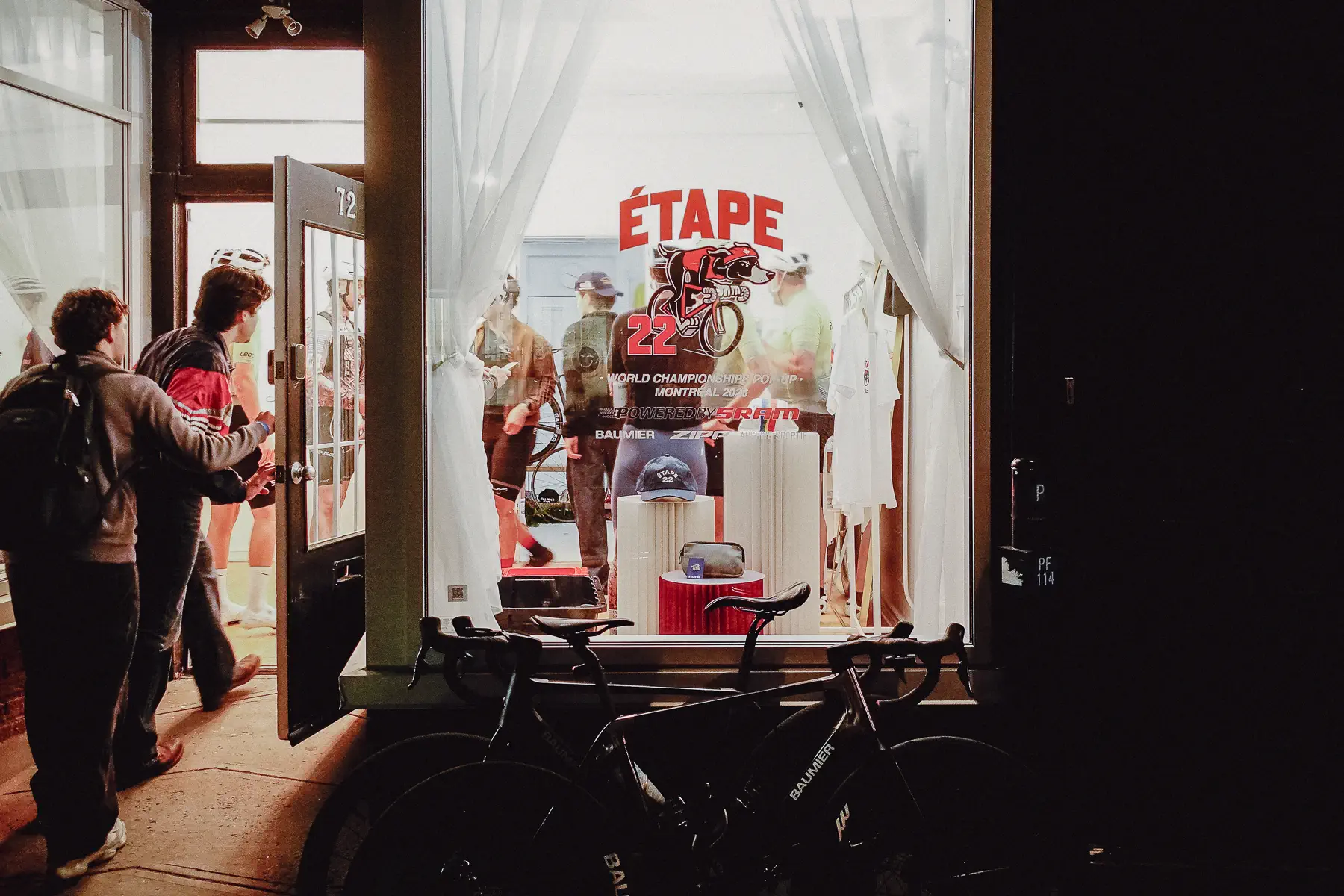 People move through the entrance of a cycling café during a quieter moment in Montréal race week