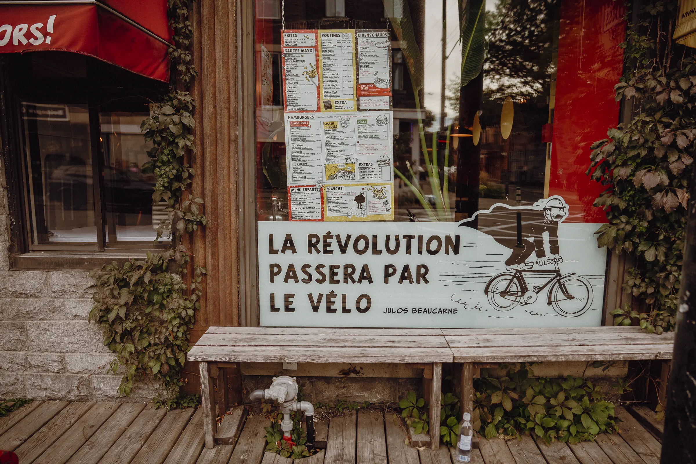 A Montréal street poster reads ‘La révolution passera par le vélo’ beside a bicycle illustration
