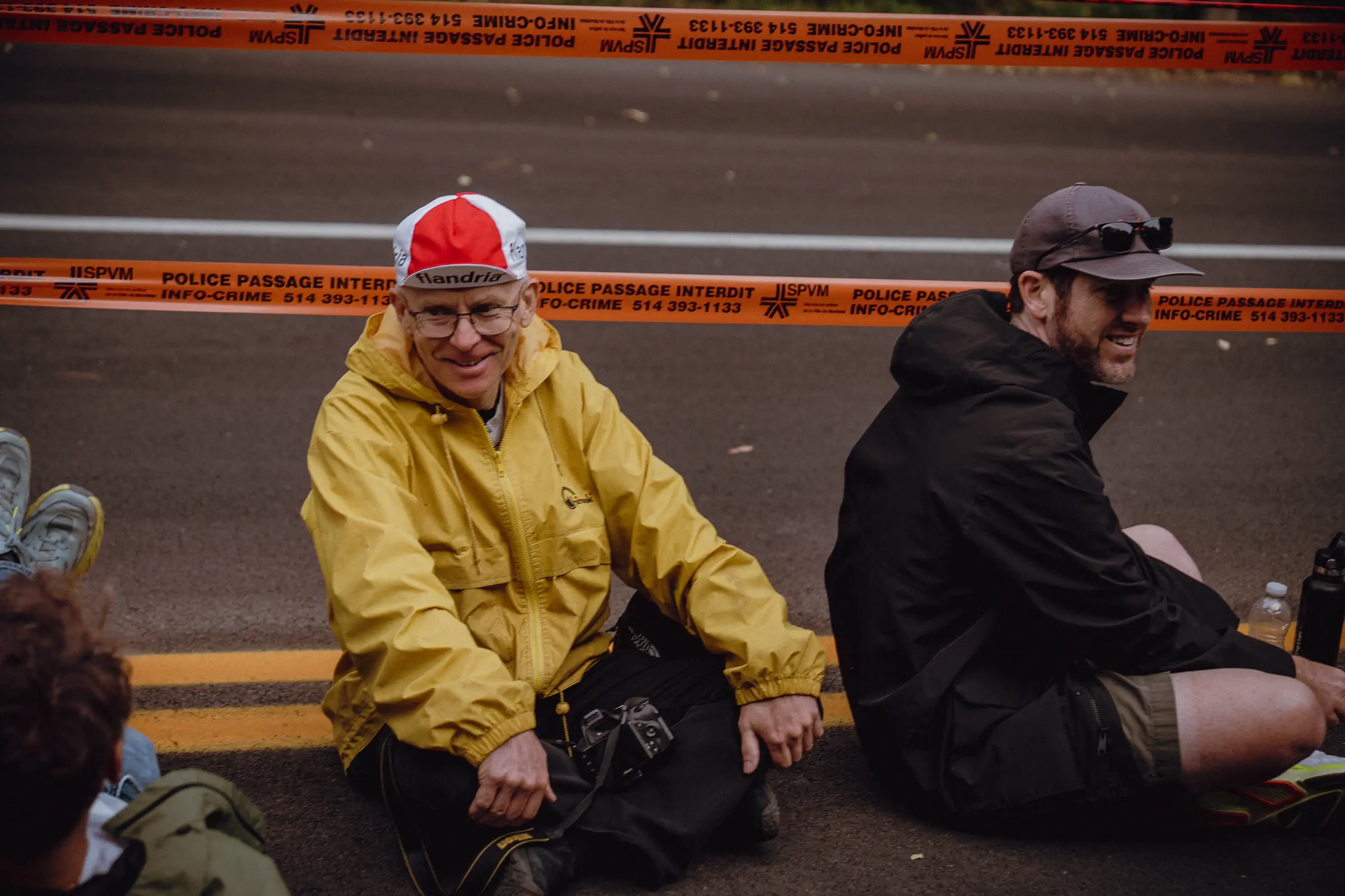 Two spectators sit quietly beside the course as the World Championships atmosphere begins to fade
