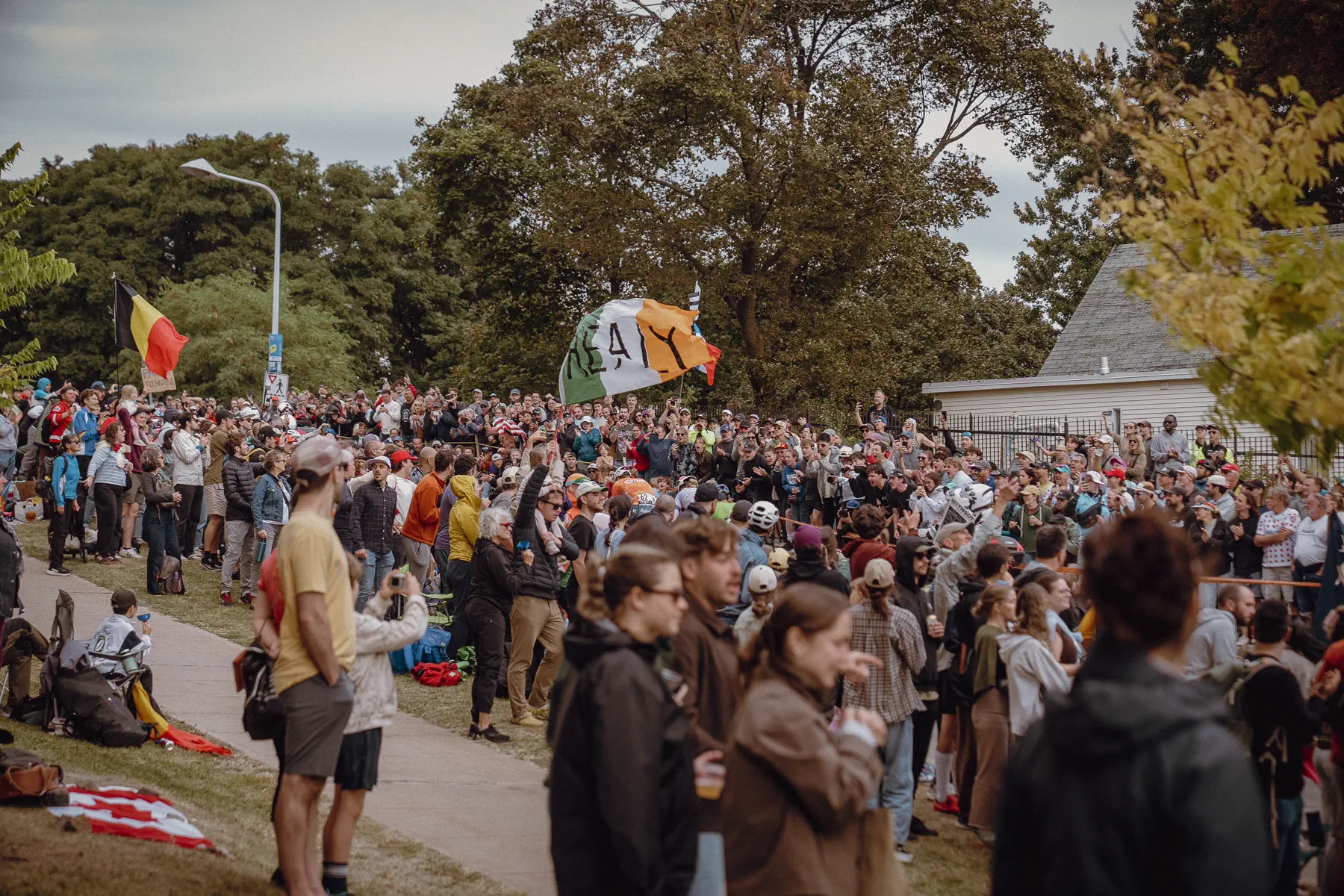 Spectators pack the grass and roadside on Mount Royal before the peloton arrives